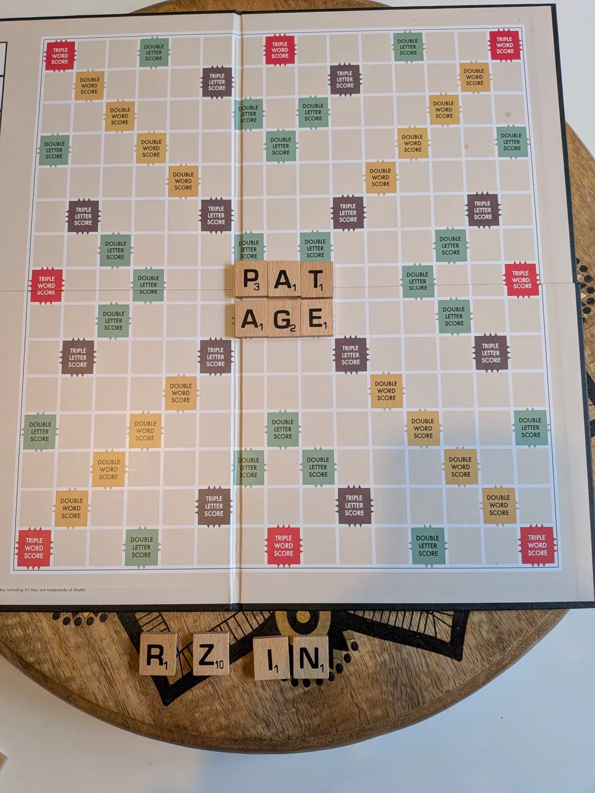 An overlap play — laying AGE flush against PAT scores off every tile they share.